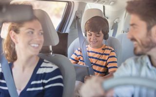 mãe e pai viajando com o filho de carro