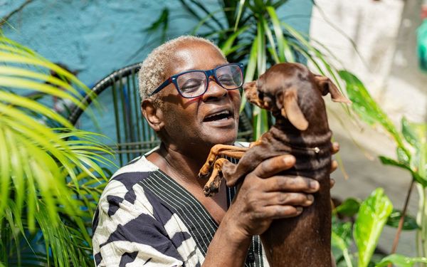mulher idosa segurando cachorro