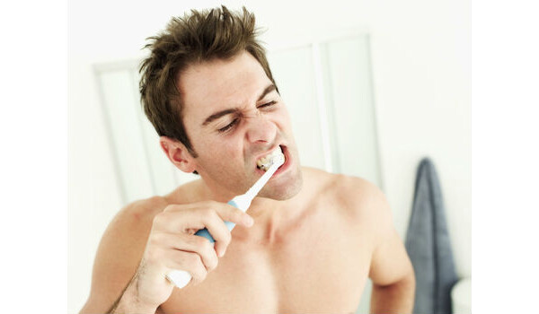 Homem escovando os dentes