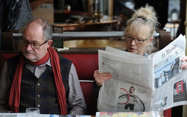 homem e mulher lendo jornal