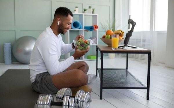 homem comendo salada com roupa de treino