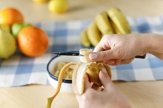 Pessoa cortando uma banana