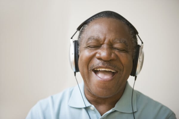 Homem idoso se divertindo ouvindo música com headphones