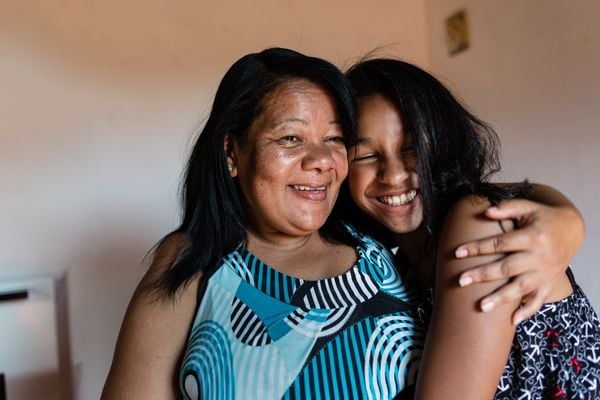 Mãe e filha abraçadas e sorridentes