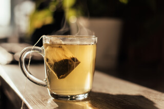 Copo de chá disposto em uma mesa de madeira