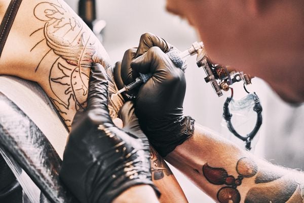 Close up tatuador fazendo tatuagem
