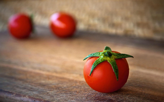 Imagem aproximada de tomate vermelho sobre tábua