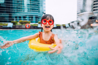 Criança com boia e óculos na piscina