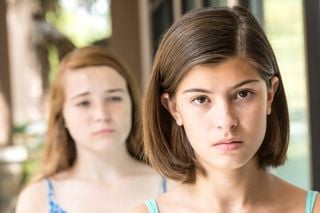 Menina ignorando outra menina que está atrás dela