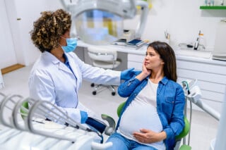 Mulher gravida em consulta no dentista
